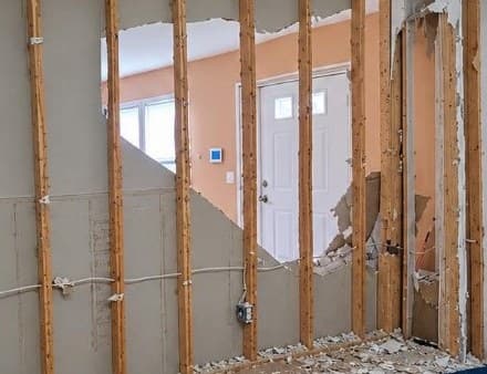 Room with drywall torn out down to the studs