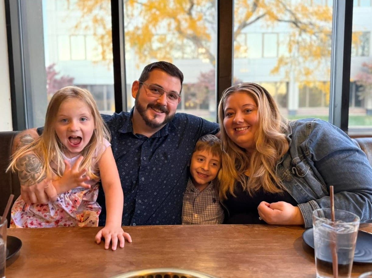 Richard with his wife, daughter, and son at a restaurant table